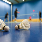 badminton - badminton courts with players competing; shuttlecock