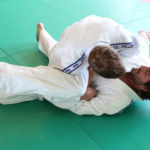 Judo practitioners in a hold on mat